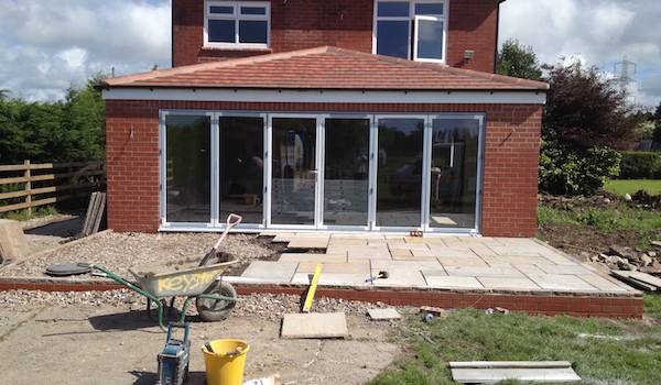A picture showing the back of a Lytham property where a refurbishment and extension is in progress, indicated by the builder tools in the garden