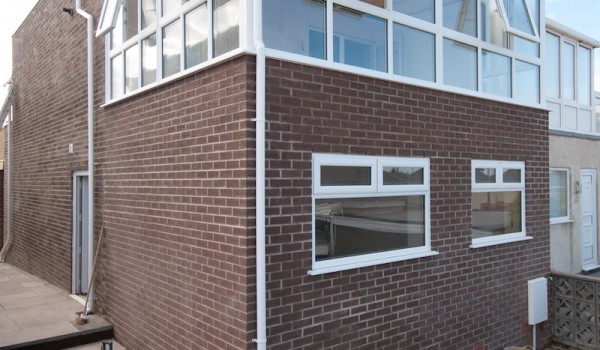 A picture showing exterior construction work on a property in Fleetwood with various builders’ tools surrounding the building