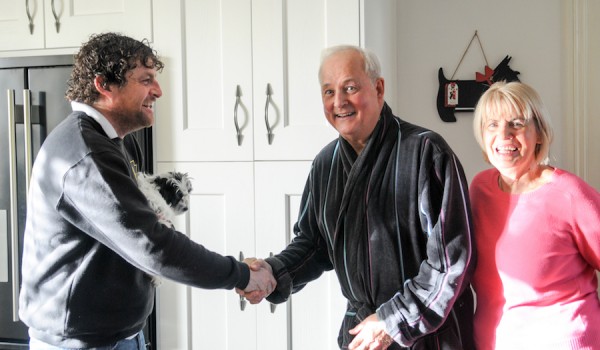 A picture showing a couple shaking hands with their Blackpool builder, their faces displaying great satisfaction with their full house renovation