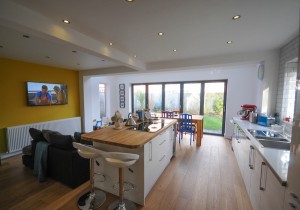 A picture showing a Blackpool communal living extension with a sleek and modern kitchen and sitting area