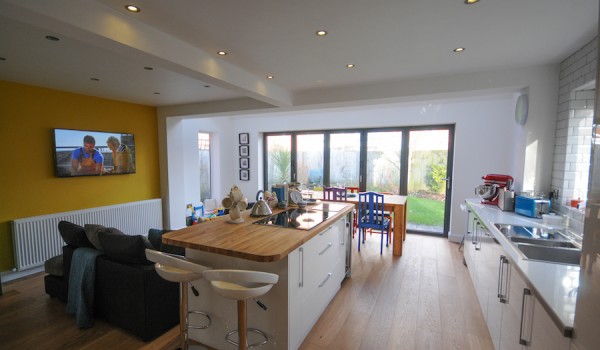 A picture showing a Blackpool communal living extension with a sleek and modern kitchen and sitting area