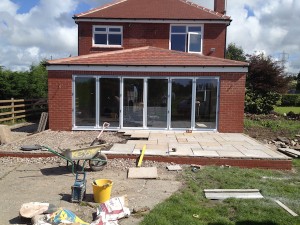 A picture showing the back of a Lytham property where a refurbishment and extension is in progress, indicated by the builder tools in the garden